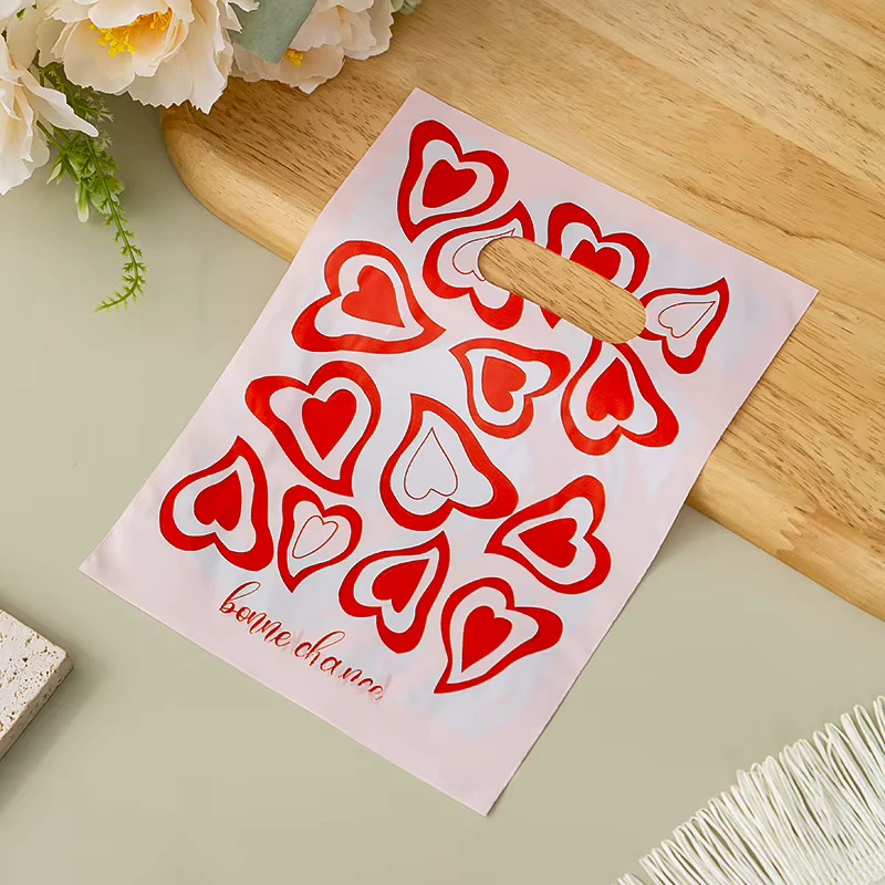 Pink Red Heart Print Plastic Merchandise Bags, Bonne Chance Die Cut Handle Bags for Retail and Boutique Stores
