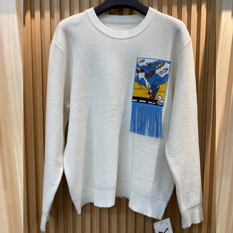 White Oversized Knit Sweater with Cartoon Graphic and Blue Fringe Detail